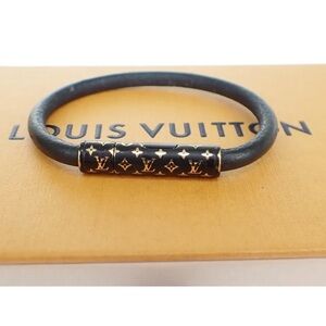 Louis Vuitton Authentic bracelet black leather with black/ gold embossed clasp.